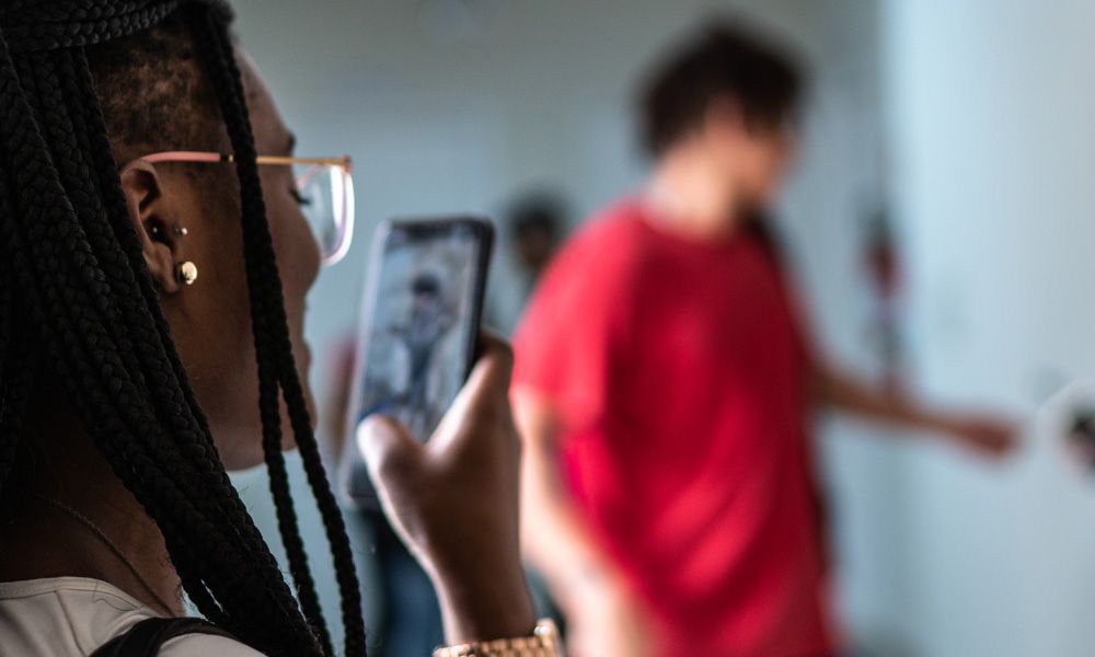 woman looking at video on mobile phone